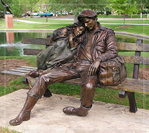 boy and girl lower statue sitting on bench
